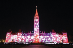 Canada's Parliament building lit up with psychedelic colors during an annual light show.
